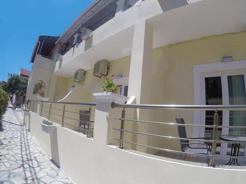 a building with balconies on the side of a street at Jessica's Studios & Apartments in Kavos