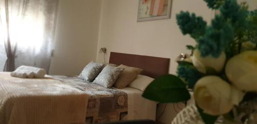 a bedroom with a bed and a couch at Dimora Sole del Sud in Ugento
