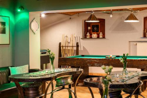 a restaurant with two tables and a pool table at Dworek 1885 in Ostrzeszów