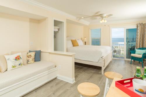 a bedroom with a bed and a couch in a room at The Saint Augustine Beach House in Saint Augustine