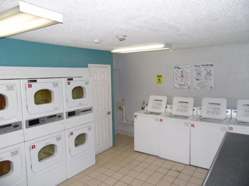 a laundry room with white washing machines and counters at InTown Suites Extended Stay Valdosta GA in Valdosta