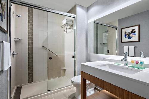 a bathroom with a sink and a shower and a toilet at Hyatt Place Grand Rapids Downtown in Grand Rapids