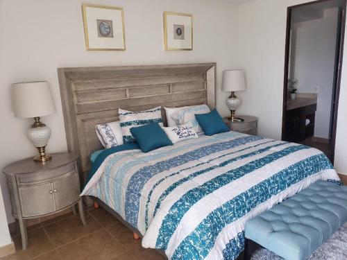 a bedroom with a bed with a blue and white comforter at Big Luxury Condo - Zona Dorada in Mazatlán