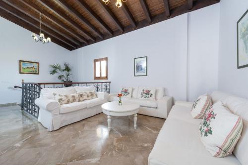 ein Wohnzimmer mit 2 weißen Sofas und einem Tisch in der Unterkunft El Palmeral in Petra