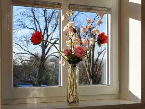 a vase filled with flowers sitting on a window sill at Sielhof Ditzum, 45222 in Ditzum