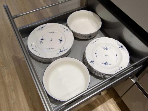 four plates and bowls sitting on a shelf at Sielhof Ditzum, 45222 in Ditzum