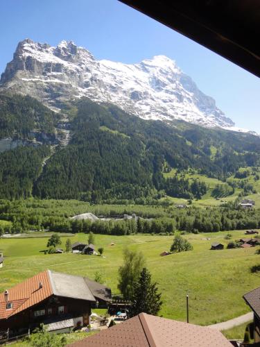 a view of a snow covered mountain with a village at Lehmann's Herberge Hostel in Grindelwald