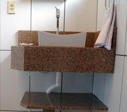 a bathroom counter with a sink in a room at Pousada Guaruja in Bombinhas