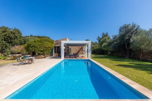 a swimming pool in the backyard of a house at Sa Plana in Son Servera