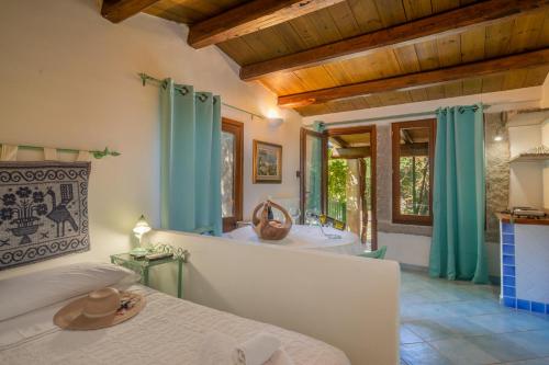 um quarto com uma casa de banho com uma banheira e uma cama em Casa Monorosa em Porto Rotondo