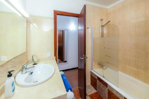 a bathroom with a sink and a shower at Es Pins Gran in Font de Sa Cala