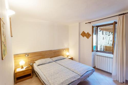 a bedroom with a bed and a window at Casa Rita app 4 in Tremosine Sul Garda