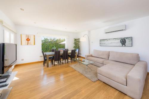 a living room with a couch and a table with chairs at Villa Costa Eugenia in Cala d´Or