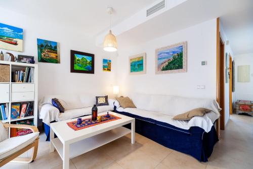 a living room with two couches and a table at Casa la fontanilla Mila in Conil de la Frontera