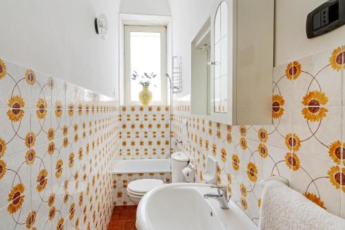 a bathroom with a toilet and a sink at Malicodia in Santa Maria di Licodia