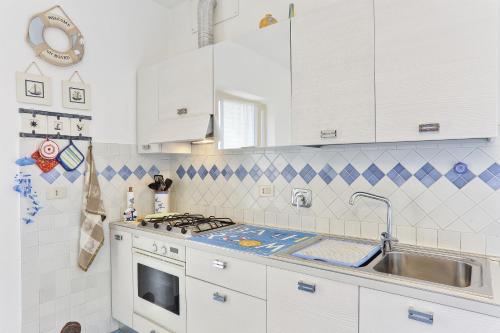 a kitchen with a stove and a sink at Appartamento Montecristo (bilocale) in Palazzo