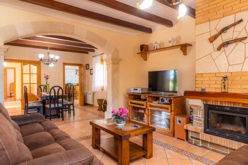 a living room with a couch and a fireplace at Can Lopez Vara in Campos
