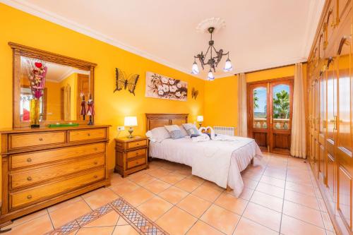 a bedroom with a bed and a dresser and a mirror at Can Lopez Vara in Campos