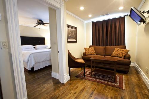 a living room with a couch and a bed at Dickson Street Inn in Fayetteville
