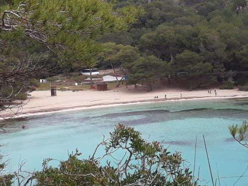a view of a beach with people walking on it at Abatzer in Ciutadella
