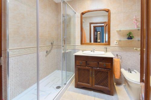 a bathroom with a shower and a sink and a toilet at Villa de la Paz in Playa Blanca