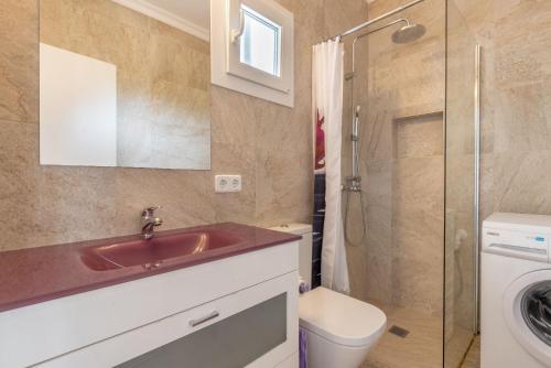 a bathroom with a sink and a toilet and a shower at Bungalow Cala Dor 27 in Cala d´Or