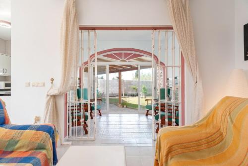 a living room with a door to a patio at Casa - 4 Mar y Arena in Barbate