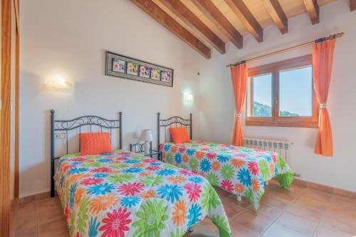 a bedroom with two beds and a window at Solluna in Son Servera