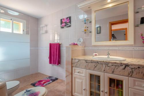 a bathroom with a sink and a toilet and a mirror at Solluna in Son Servera