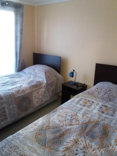 two beds sitting next to each other in a bedroom at Cabañas Rivadavia Spa in Vicuña