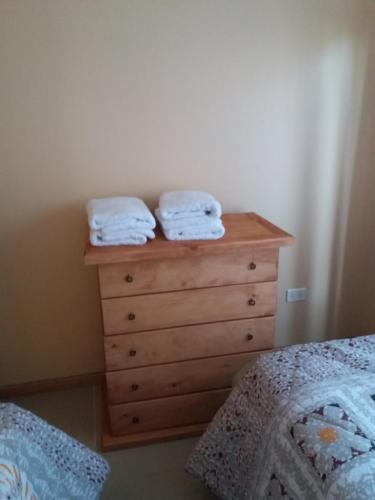a bedroom with a dresser with two towels on it at Cabañas Rivadavia Spa in Vicuña