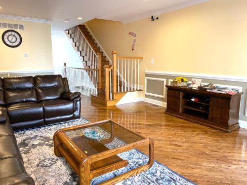 a living room with a leather couch and a coffee table at Alina & Fanny - Philadelphia 1210 Mt Vernon St in Philadelphia
