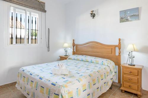 a bedroom with a bed and a window at Bungalows La Aceitera - Apartamento 2 in Zahora
