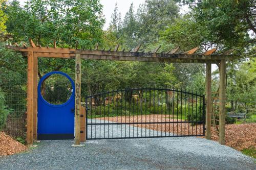 a gate with a blue door and a fence at Sehome Garden Inn in Bellingham