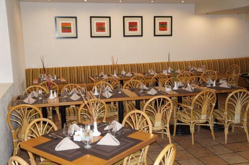a row of tables and chairs in a restaurant at Casa Grande Chihuahua in Chihuahua
