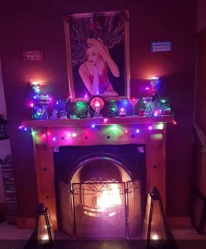 a fireplace with christmas lights on top of it at Clare Street B&B in Nenagh