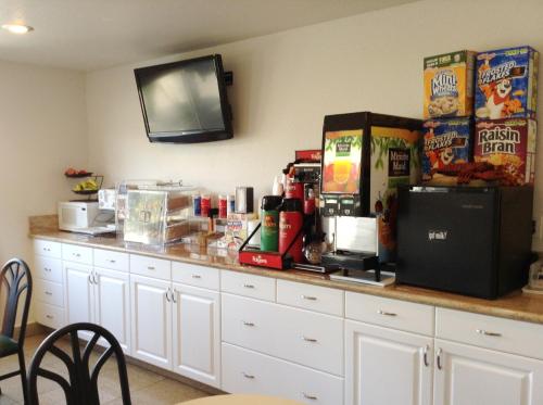 a counter with food and drinks on top of it at Days Inn by Wyndham Oceanside in Oceanside