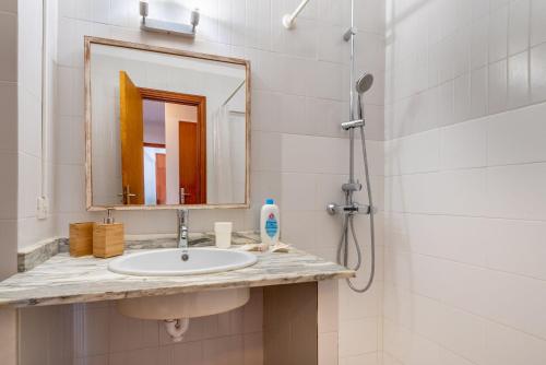 a bathroom with a sink and a mirror at Bennassar 2 in Felanitx
