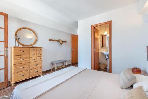 a bedroom with a large white bed and a mirror at Bennassar 2 in Felanitx