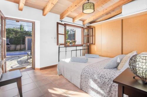 a bedroom with a bed and a large window at Ca'n Doi in Sóller