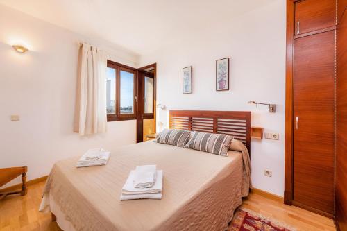 1 dormitorio con 1 cama con 2 toallas en S'algar, en Portocolom