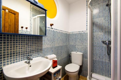 uma casa de banho com um lavatório, um WC e um chuveiro em Apartamento Rural De Oses 2 em Totalán