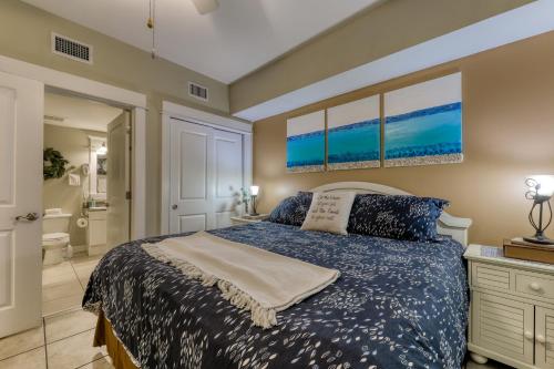 a bedroom with a bed and a bathroom at Grand Panama Beach Resort #T1-1402 in Panama City Beach