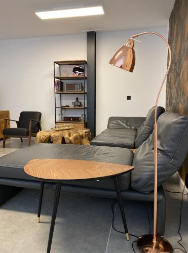 a living room with a couch and a table at City Apartments Hannover in Hannover