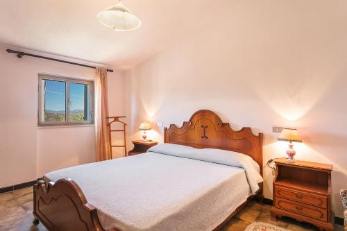 a bedroom with a large bed and a window at Casa Marianna in Porto San Paolo