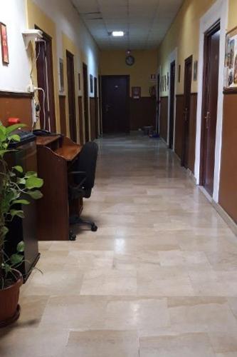an empty hallway of an office building with a hallway at Ostello Marello in Rome