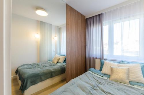 Posteľ alebo postele v izbe v ubytovaní Apartament Różana