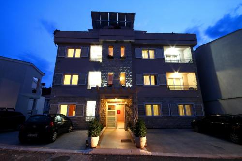 a large building with its lights on at Petrovac Holiday Apartments in Petrovac na Moru