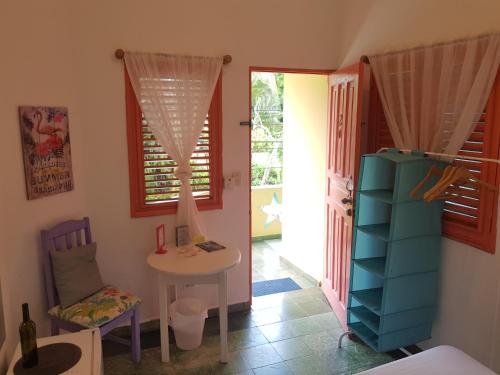 a room with a table and a chair and a table at Casa Delfin Guest House in Las Terrenas