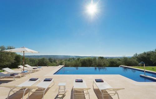 a swimming pool with lounge chairs and a swimming pool at Sa Garriga in Ariany
